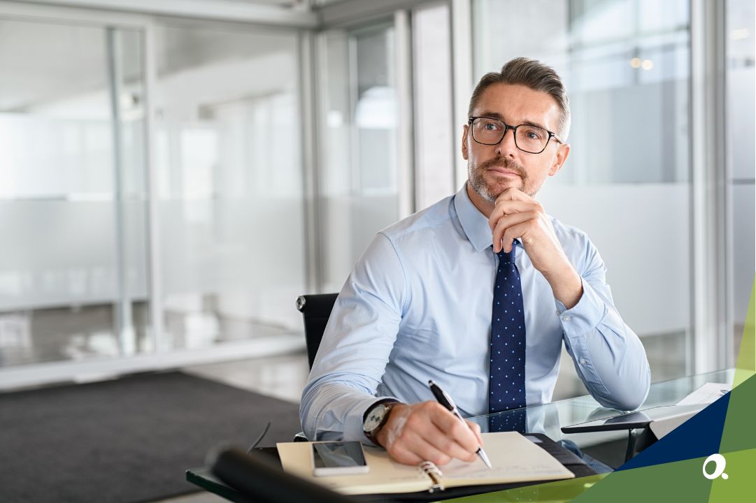 Working man sitting by a computre, thinking