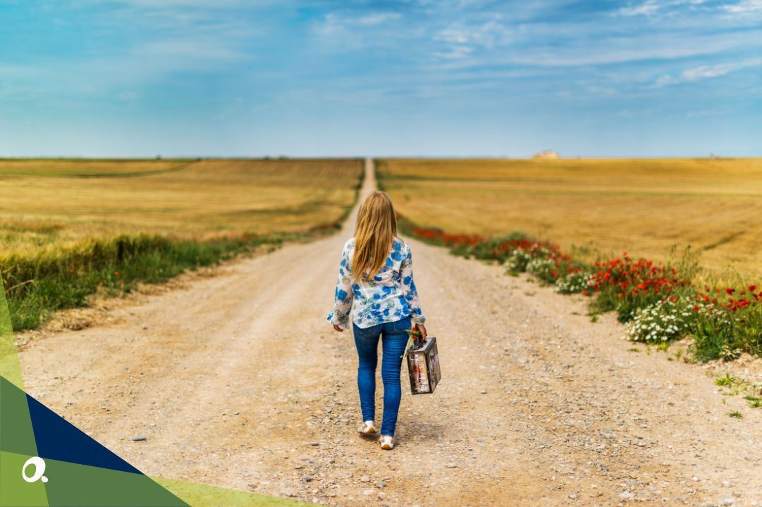 Woman standing on a long road