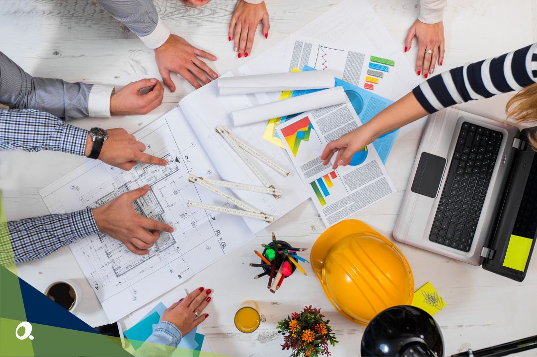 Construction team discussing a blueprint over a table