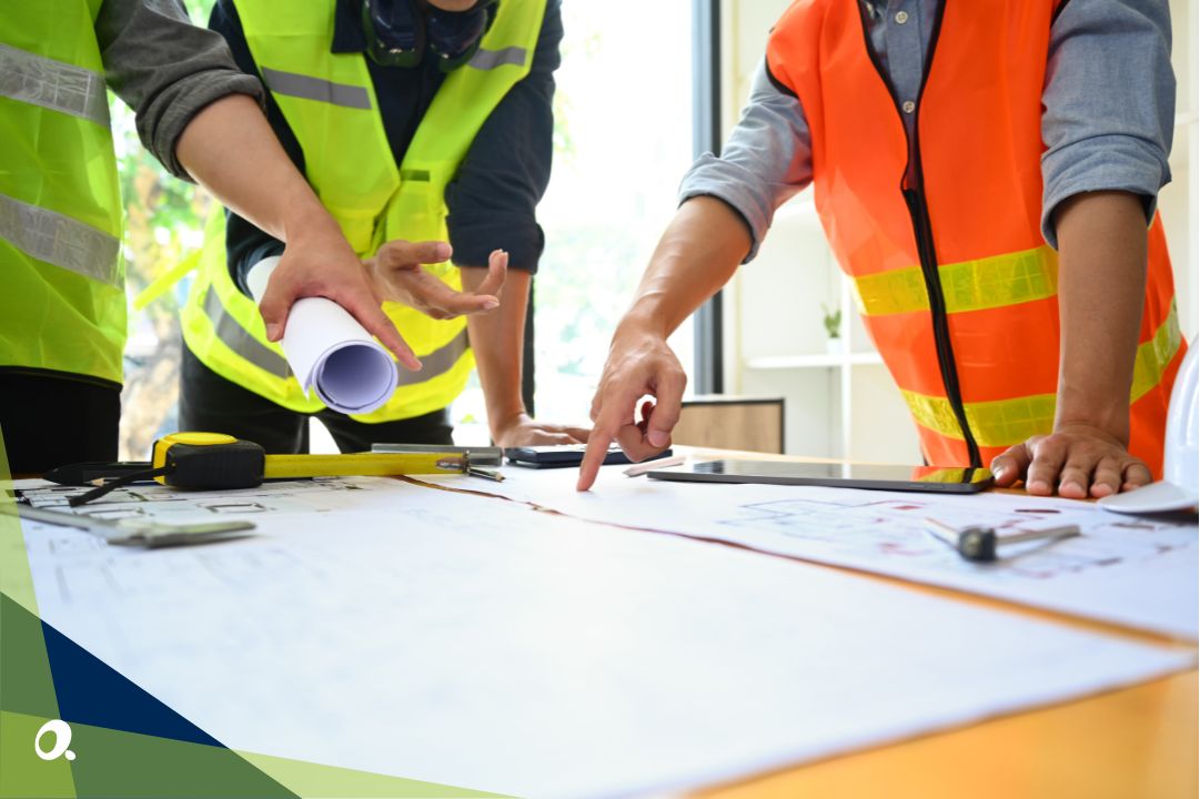 Construction team reviewing building site plans