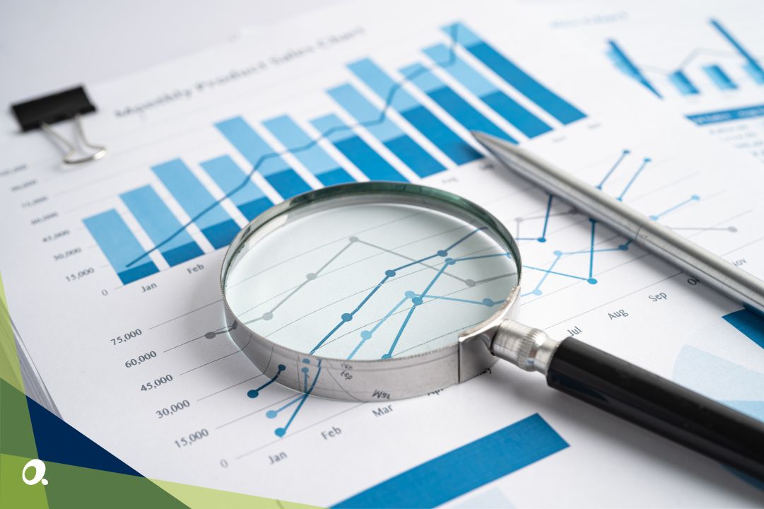 Printed financial report sitting underneath a magnifying glass