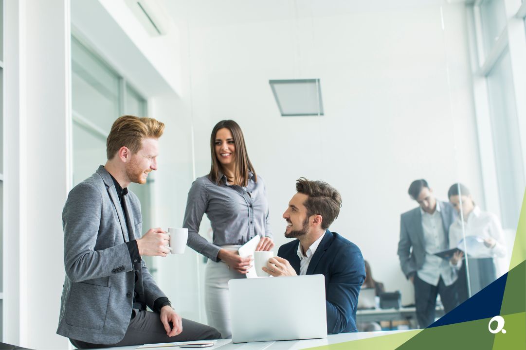 Finance team gathering around a laptop in discussion