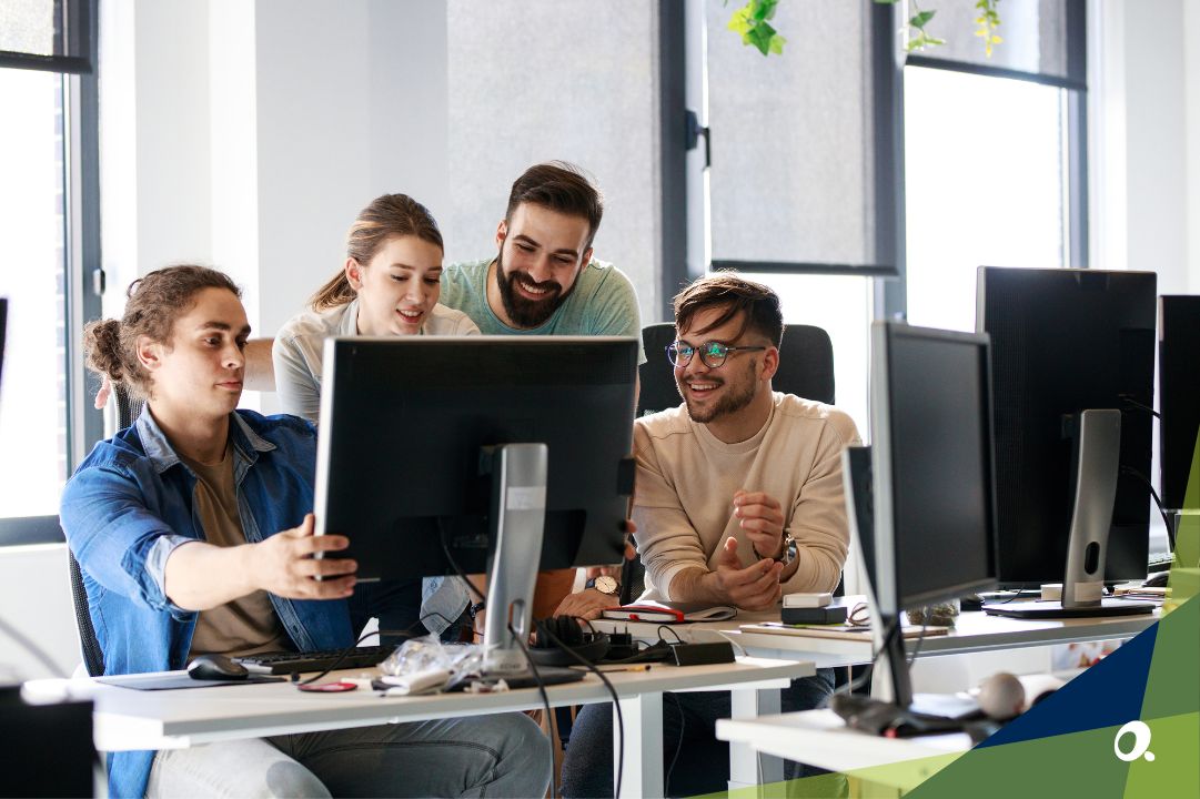 Finance team gathered around a computer