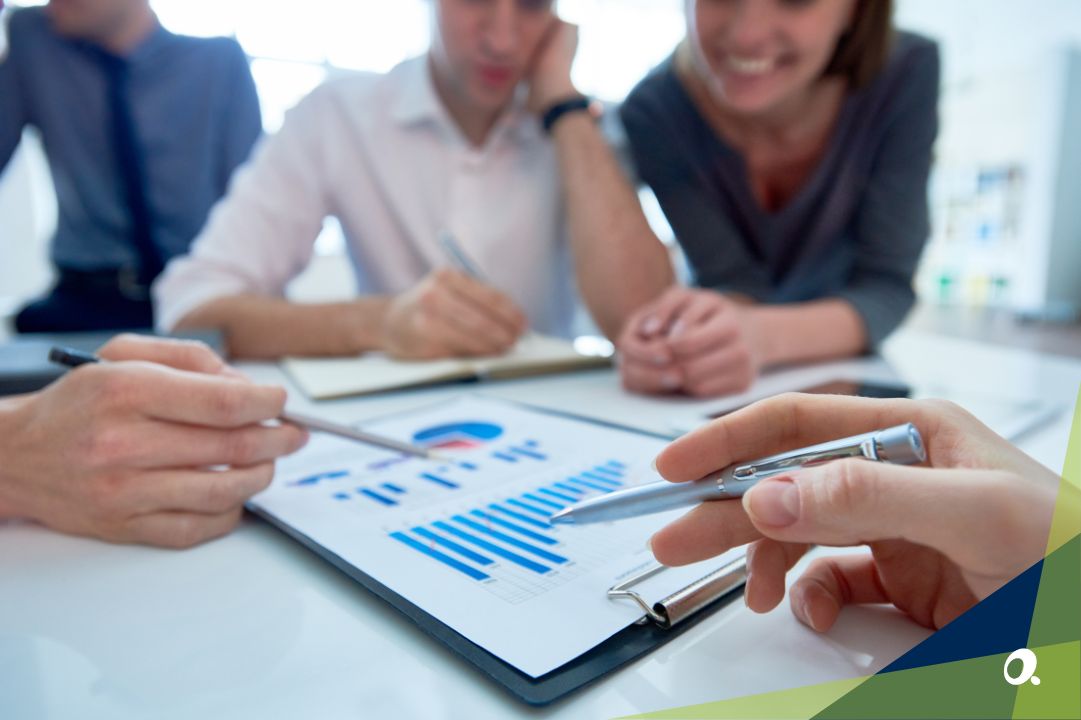 A team collaborating around a desk with financial documents