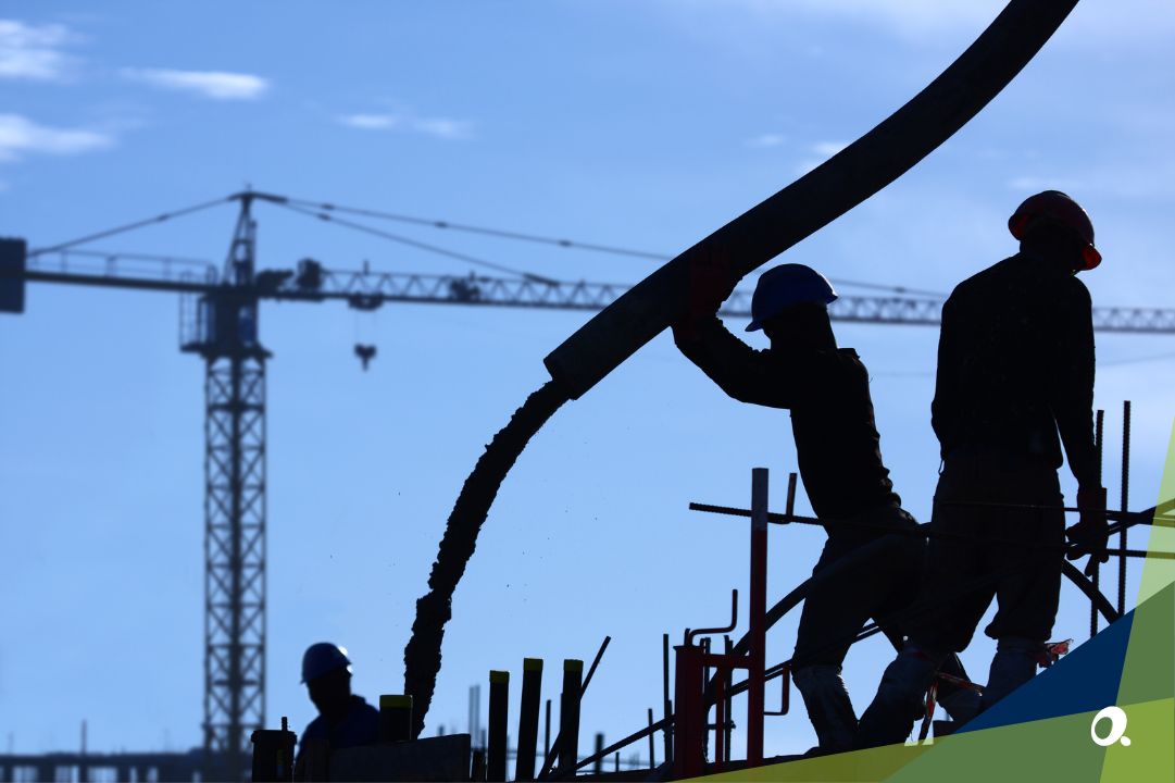 Silhouette of construction workers working at a building site