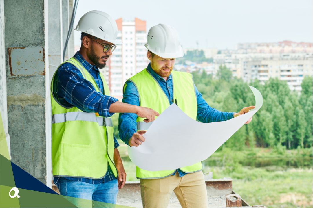 Two construction worker colleagues reviewing plans on-site