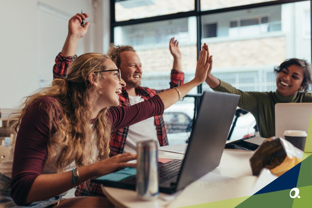 A successful and happy finance team sitting around a large desk