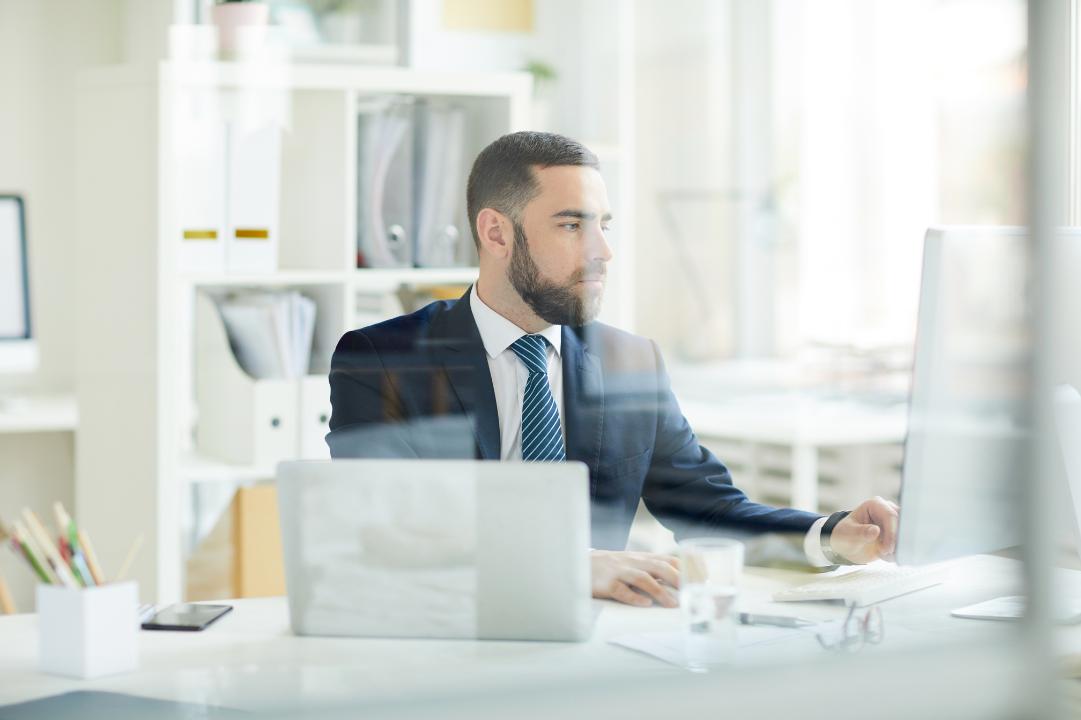 Man at his desk utilising advanced financial forecasting techniques