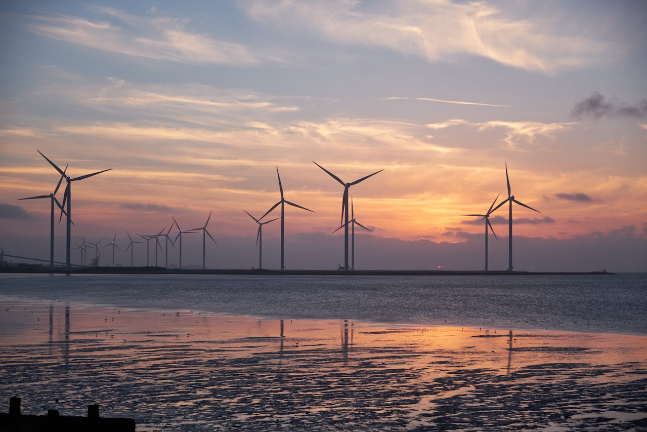 A row of wind turbines during dusk