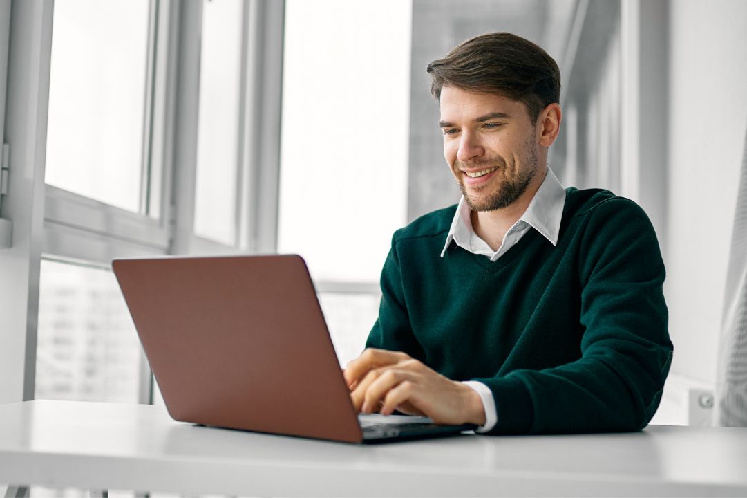 Man smiling as he enjoys the many benefits of the Sage Intacct system